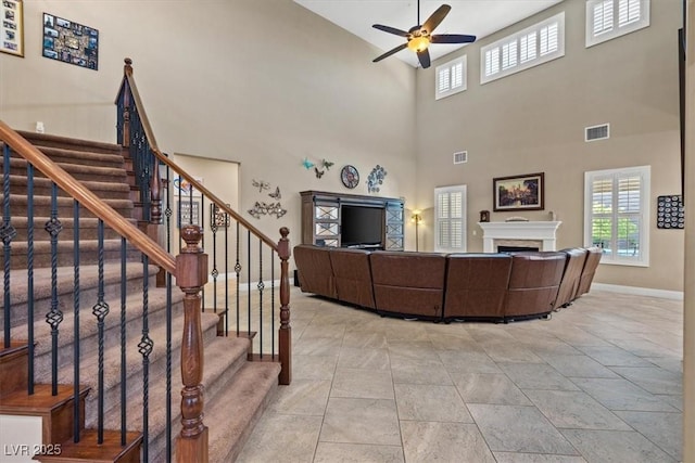 2920 Josephine Dr, Henderson, NV 89044 - living area with a fireplace, ceiling fan, stairs, and a towering ceiling