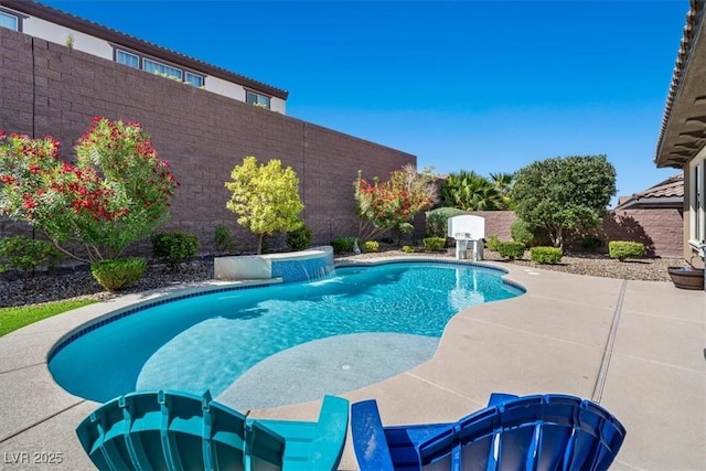 view of swimming pool featuring pool water feature and a patio