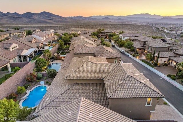 aerial view at dusk featuring a mountain view