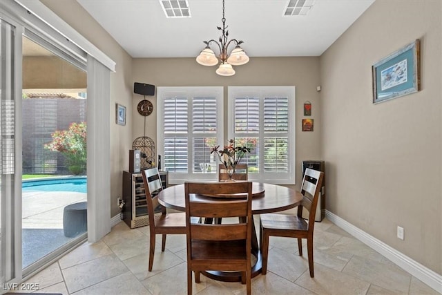 dining area featuring beverage cooler and a chandelier