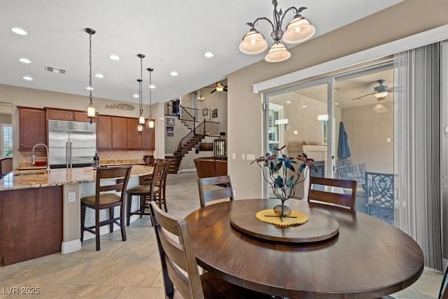 dining space with ceiling fan and sink