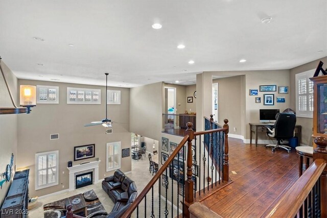 2920 Josephine Dr, Henderson, NV 89044 - living room with a desk, recessed lighting, healthy amount of natural light, and a fireplace with flush hearth
