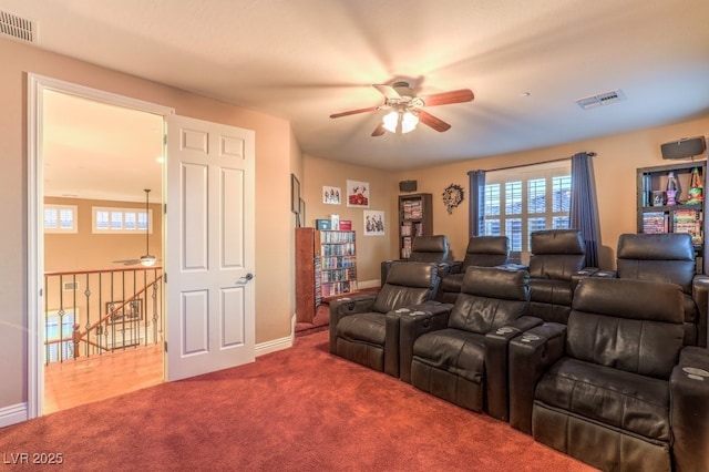 carpeted cinema room featuring ceiling fan