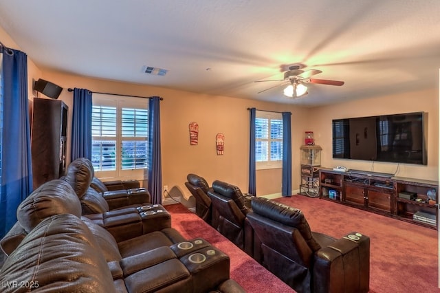 carpeted cinema featuring ceiling fan