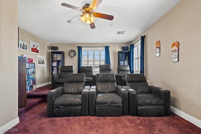 carpeted cinema room featuring ceiling fan