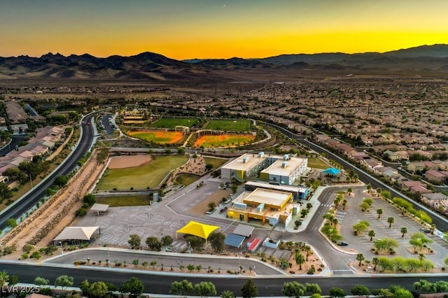 aerial view at dusk featuring a mountain view