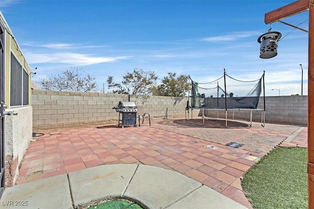 view of patio featuring grilling area and a trampoline