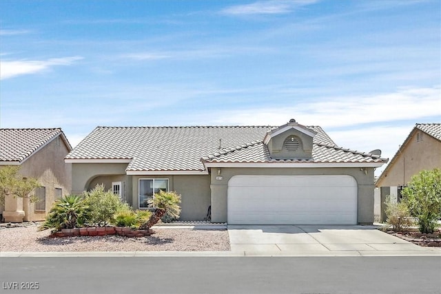 5915 Ablette Ave, Las Vegas, NV 89122 - mediterranean / spanish house with stucco siding, concrete driveway, an attached garage, and a tile roof