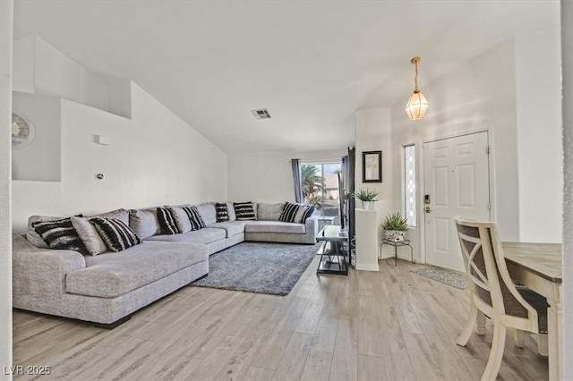 5915 Ablette Ave, Las Vegas, NV 89122 - living area with light wood-style flooring and lofted ceiling