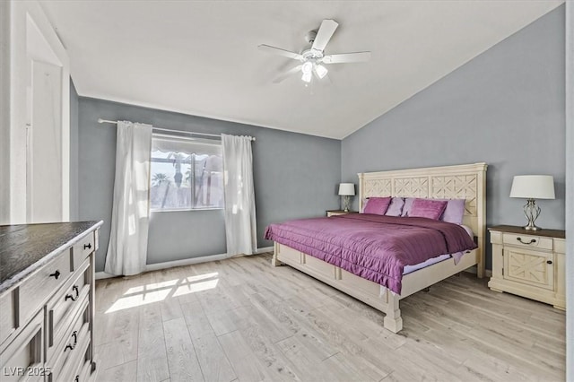 bedroom with ceiling fan, vaulted ceiling, and light hardwood / wood-style flooring