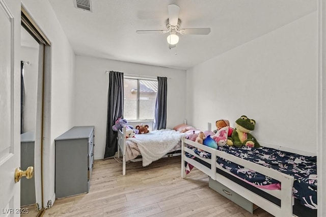 bedroom with light hardwood / wood-style floors and ceiling fan