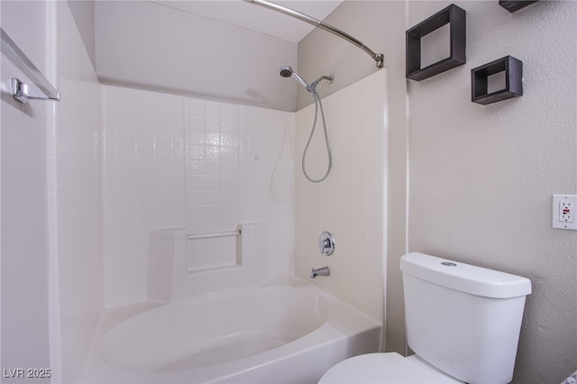 bathroom featuring shower / bathing tub combination and toilet