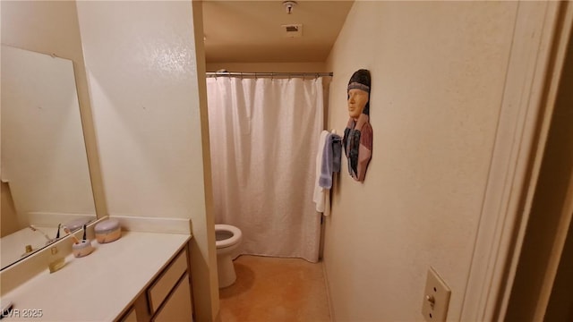 bathroom featuring vanity and toilet