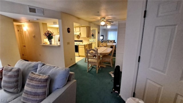 living room with ceiling fan and carpet floors