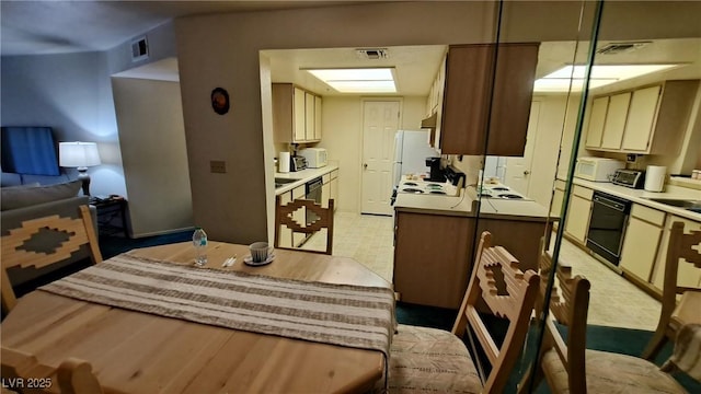 kitchen featuring cream cabinets, sink, and white appliances