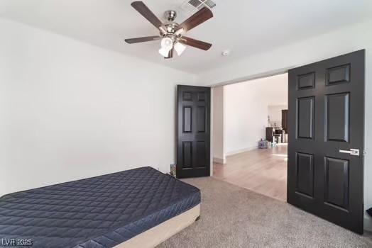 carpeted bedroom with ceiling fan