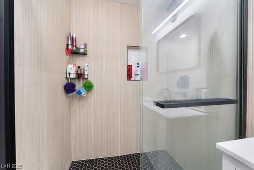 bathroom with vanity and a shower