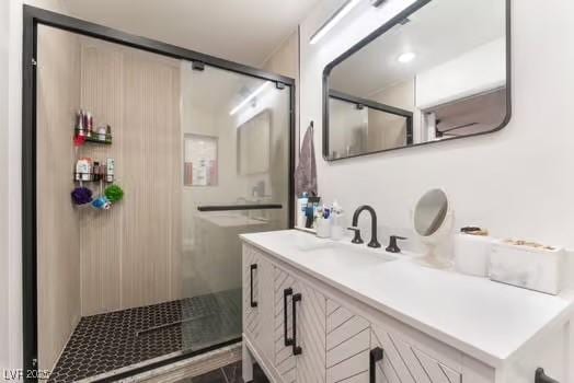 bathroom with vanity and a shower with door