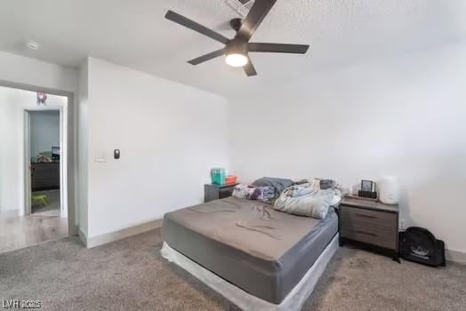 carpeted bedroom featuring ceiling fan