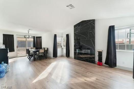 living room with a chandelier and light hardwood / wood-style flooring