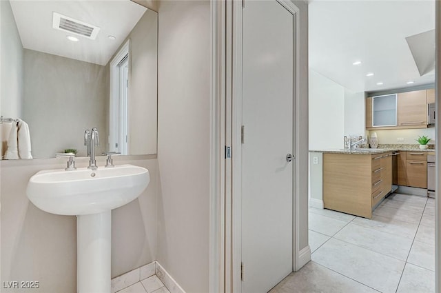 bathroom featuring tile patterned flooring and sink