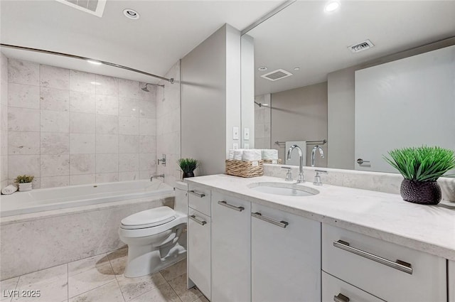 full bathroom with tiled shower / bath combo, vanity, and toilet