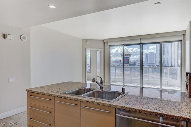 kitchen with dishwasher, sink, light tile patterned flooring, and light stone counters