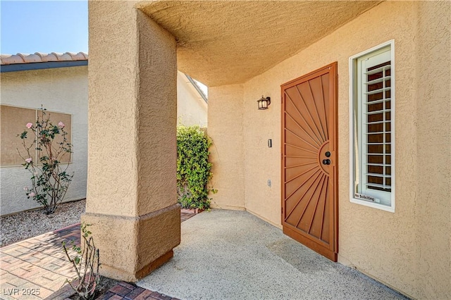 doorway to property featuring a patio area