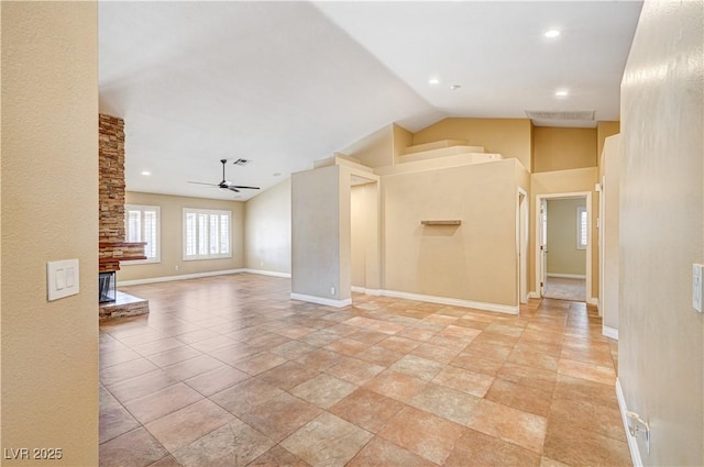 interior space with ceiling fan and vaulted ceiling