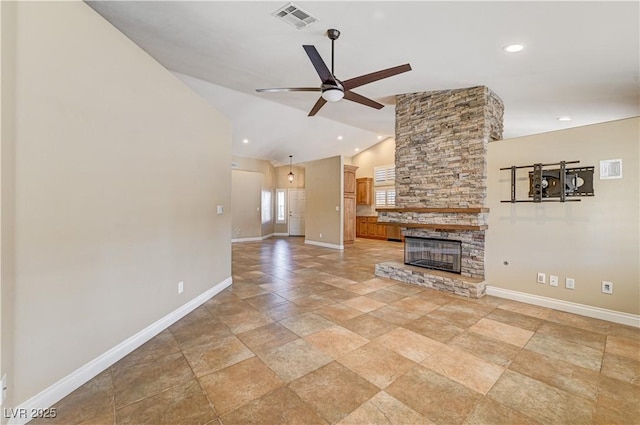 unfurnished living room featuring a stone fireplace, vaulted ceiling, and ceiling fan