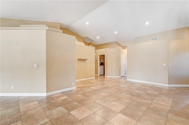 tiled spare room featuring lofted ceiling