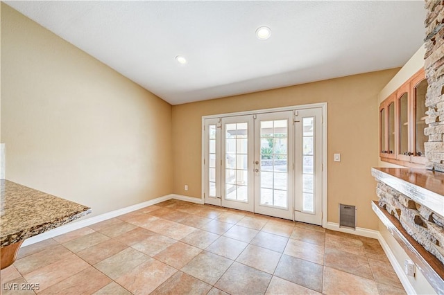 doorway featuring light tile patterned floors and french doors