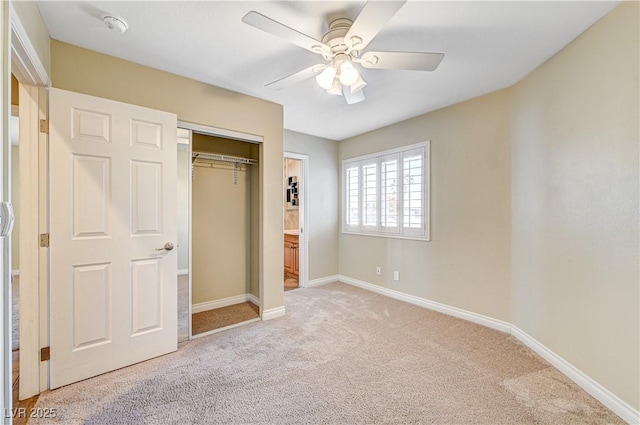 unfurnished bedroom featuring light colored carpet, ceiling fan, and a closet