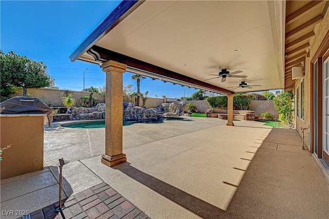 view of patio / terrace with pool water feature, ceiling fan, and a fenced in pool