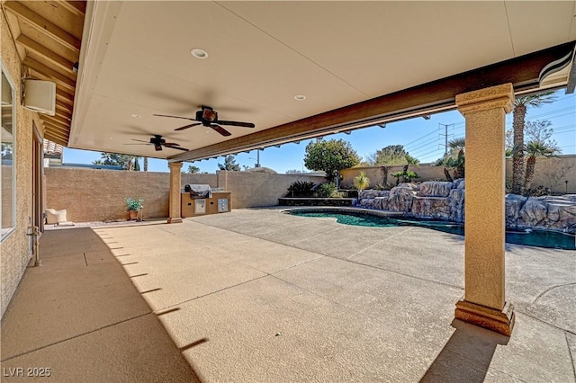 view of patio with a fenced in pool, pool water feature, and ceiling fan