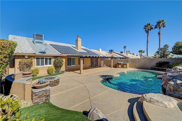 view of pool featuring cooling unit, an outdoor fire pit, and a patio area