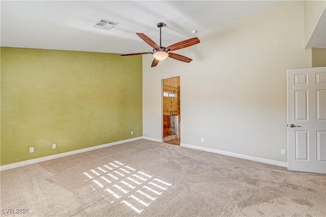 carpeted empty room with ceiling fan and high vaulted ceiling