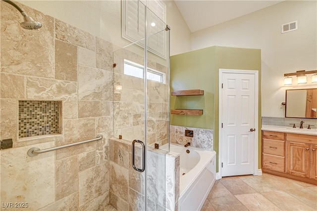 bathroom with lofted ceiling, tile patterned flooring, vanity, tasteful backsplash, and shower with separate bathtub