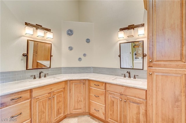 bathroom featuring vanity and decorative backsplash