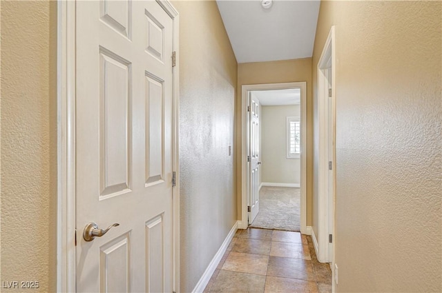 corridor featuring light tile patterned flooring