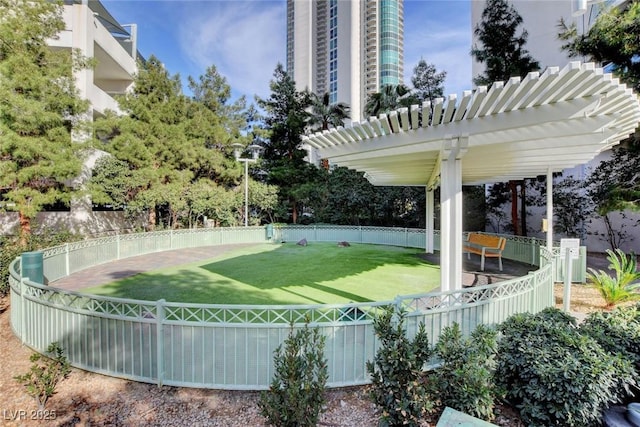 view of community with a yard and a pergola