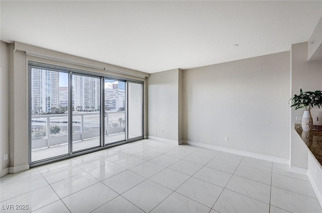 spare room featuring light tile patterned floors