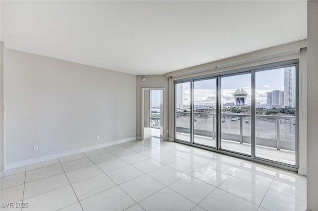 spare room featuring light tile patterned floors