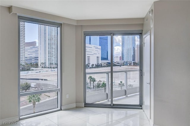 doorway to outside featuring light tile patterned floors and plenty of natural light