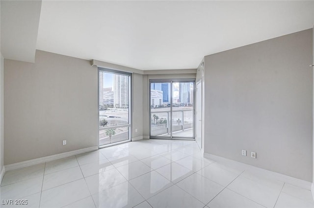 unfurnished room featuring light tile patterned floors