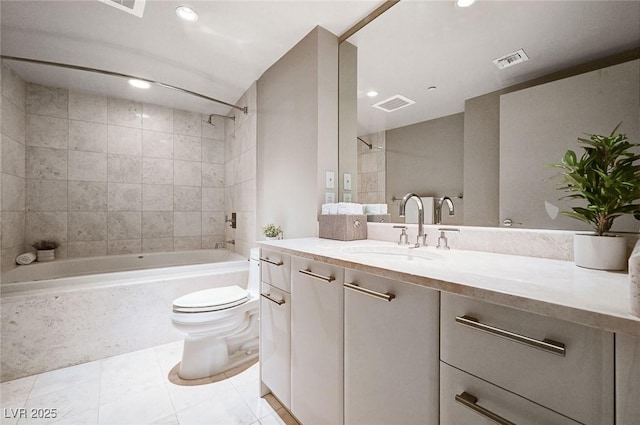 full bathroom with tile patterned floors, vanity, toilet, and tiled shower / bath combo