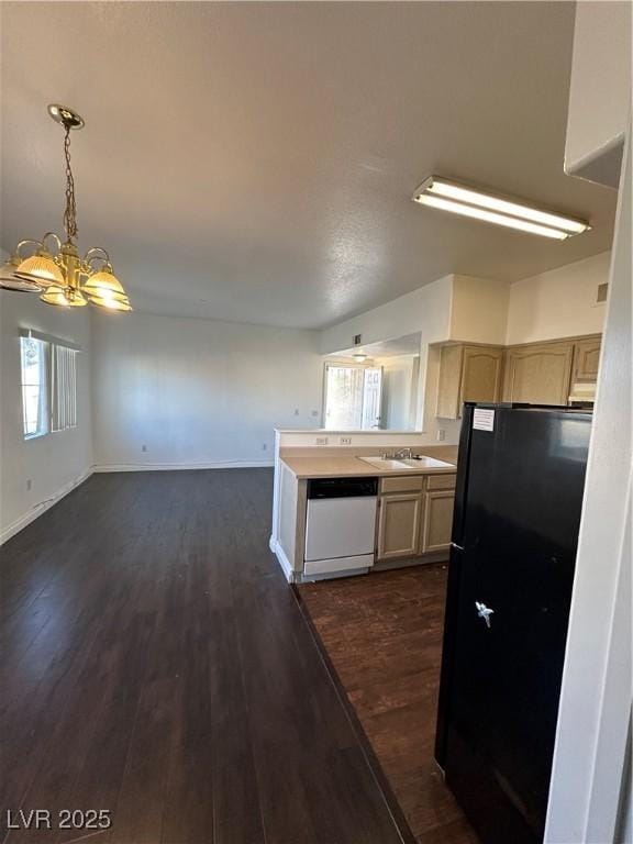 kitchen with black fridge, dark hardwood / wood-style floors, light brown cabinets, and white dishwasher