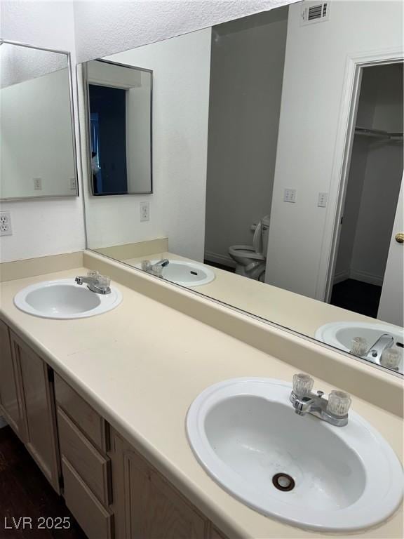 bathroom featuring hardwood / wood-style flooring, vanity, and toilet