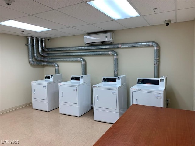 clothes washing area with washing machine and dryer