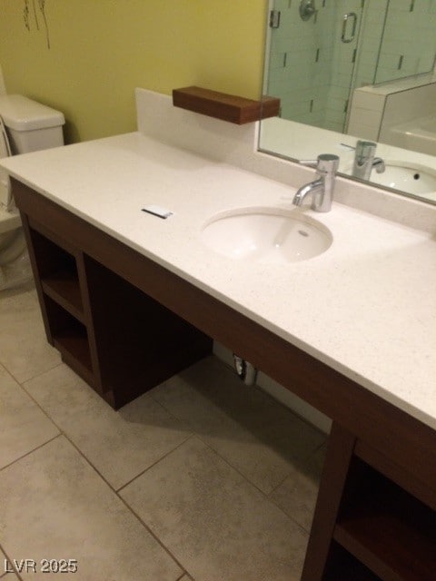 bathroom featuring an enclosed shower, vanity, tile patterned floors, and toilet